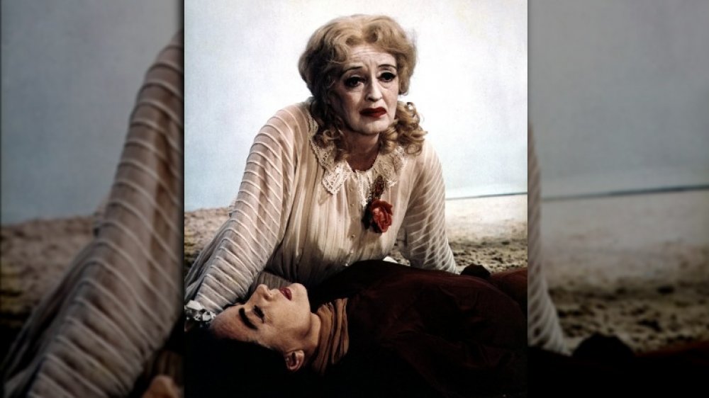 Bette Davis sitting over Joan Crawford in What Ever Happened to Baby Jane?