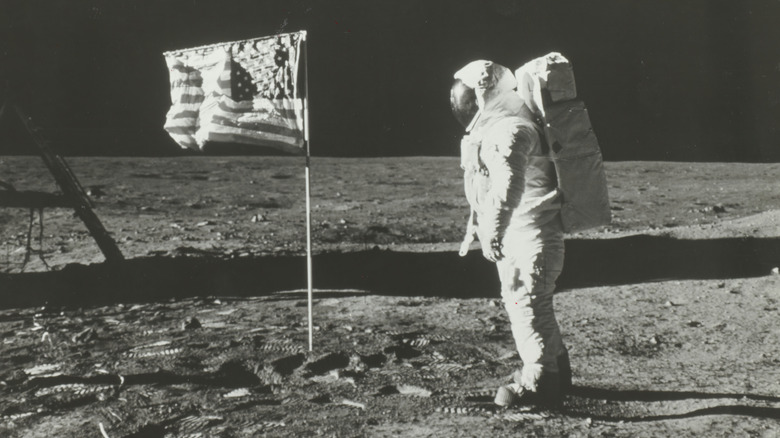 astronauts plant flag on moon