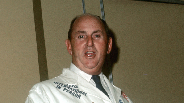 Colonel Tom Parker in white Elvis International suit