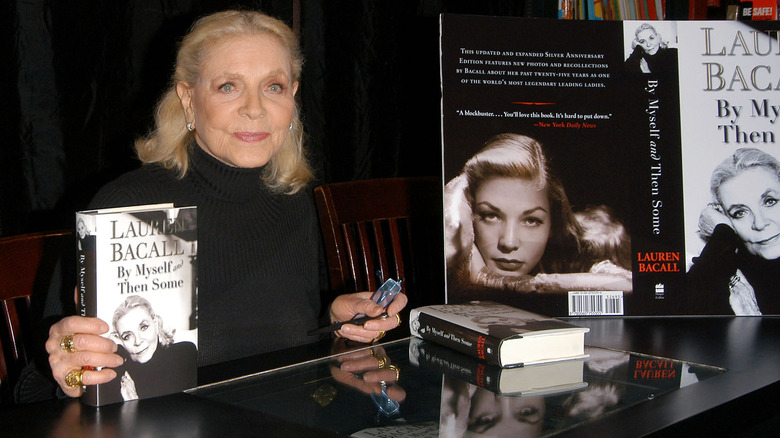 Lauren Bacall posing with her book