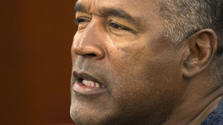 OJ Simpson squinting mouth open