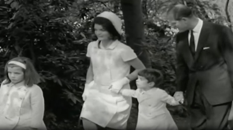 Jackie Kennedy and Prince Philip holding hands with John Junior climbing stairs