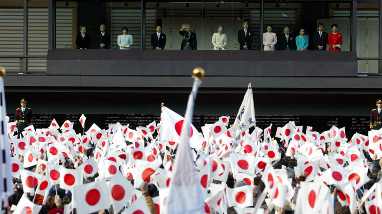 Imperial family members wave to crowd