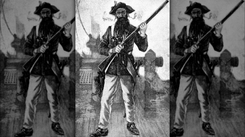 blackbeard standing with rifle