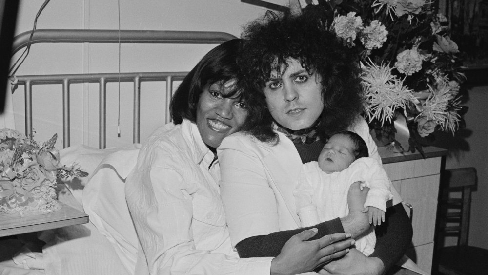 Marc Bolan and Gloria Jones cradling their son Rolan