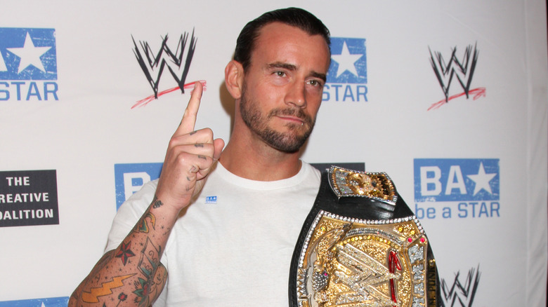 CM Punk holding the WWE championship