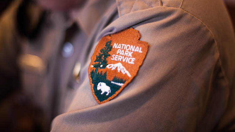 park official and National Park patch