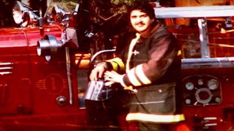 Paul Vasquez poses on fire truck