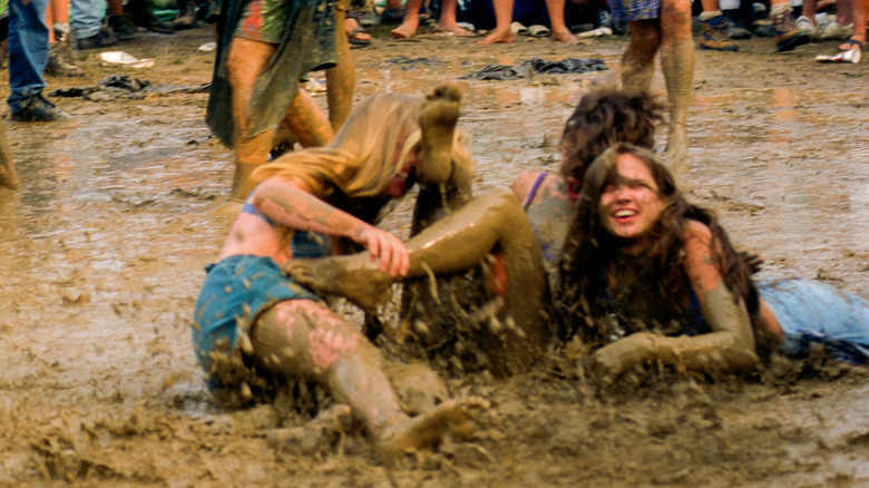 people playing in mud