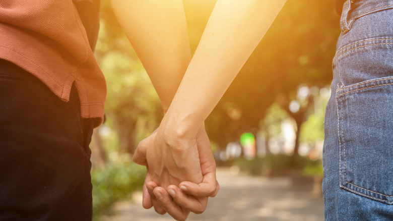 Man and woman holding hands