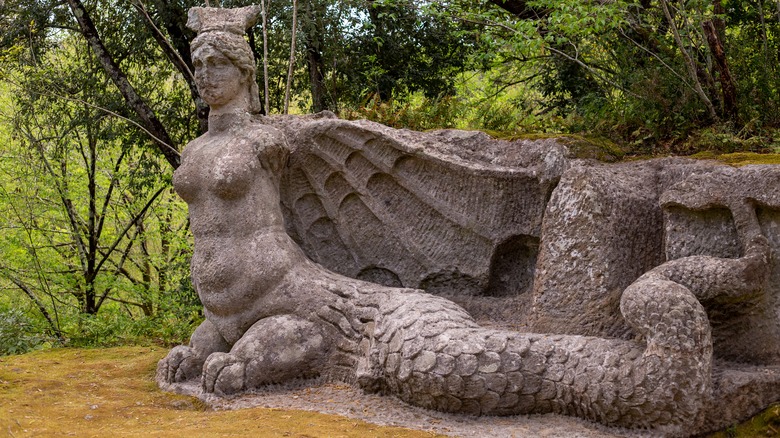 Siren sculpture with wings and fish tail