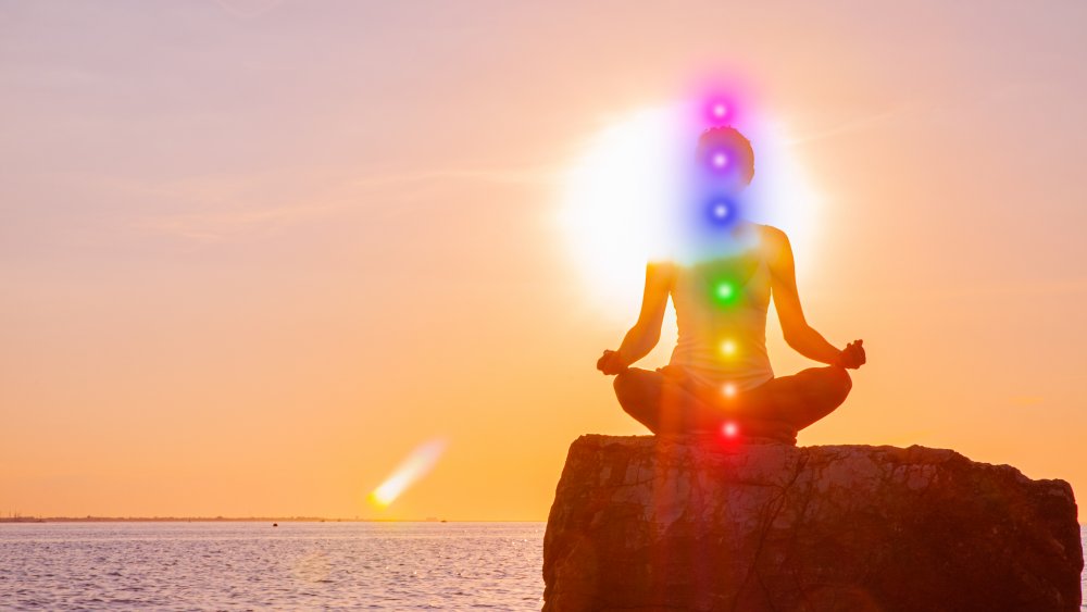 A picture of chakras in a meditating women 