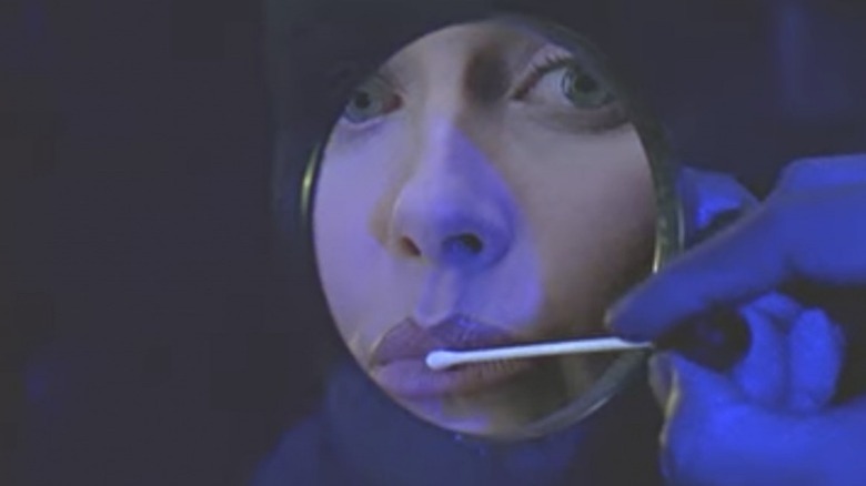 Woman has her lips swabbed at a kiosk