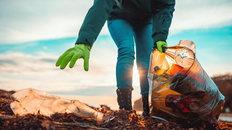 Person collects trash and bottles