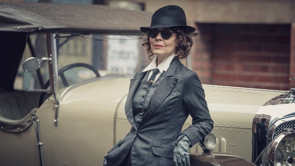 Aunt Polly from "Peaky Blinders" leaning against car