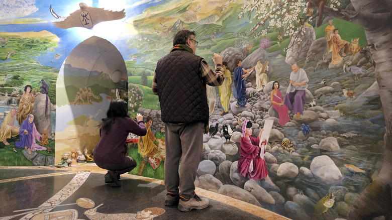 Fresco painter in the Hall of the Earth, interior of the "Temples of Humankind" built by Damanhur community, on March 1, 2019 in Baldissero Canavese, Italy