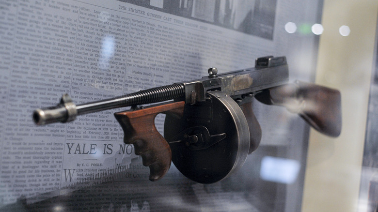 tommy gun museum display case newspaper background