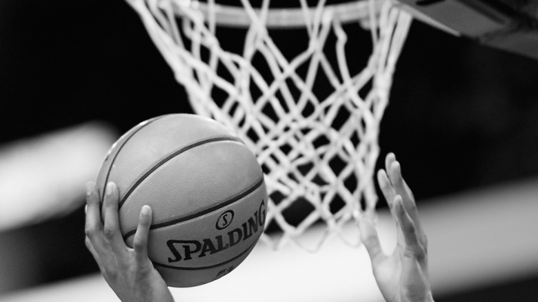 basketball, hoop, and players' hands