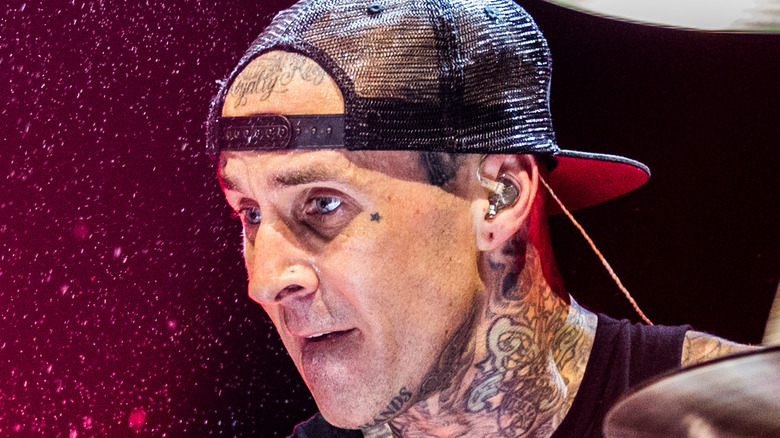 Travis Barker wears an earpiece