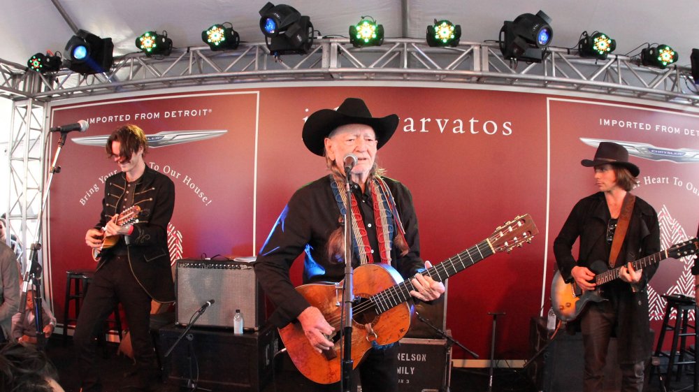 Willie Nelson performing with his sons, Micah and Lukas