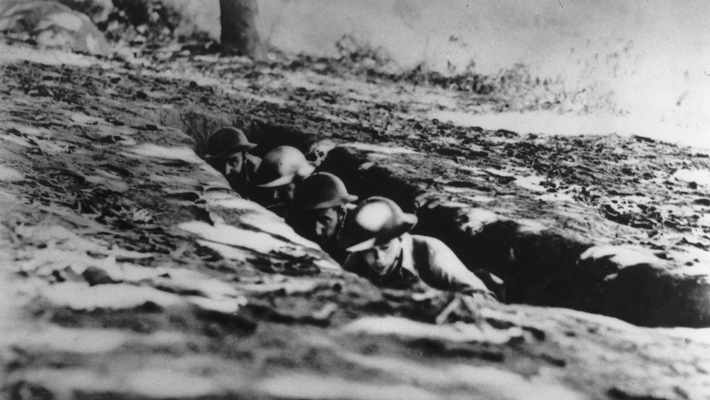 American and Filipino soldiers in a foxhole during the Battle of Bataan