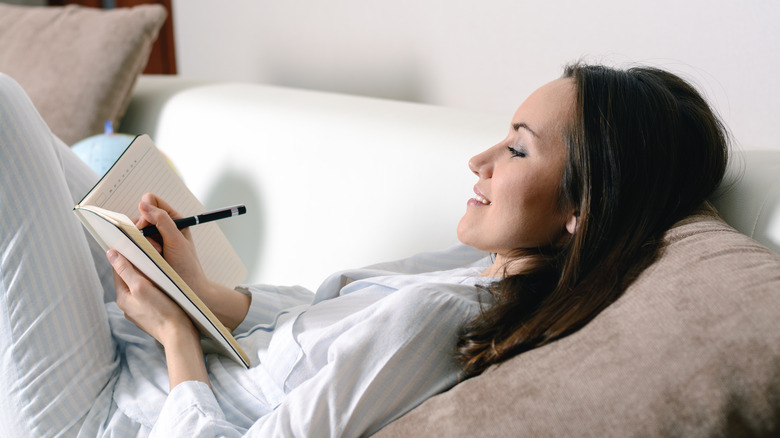 woman in bed writing