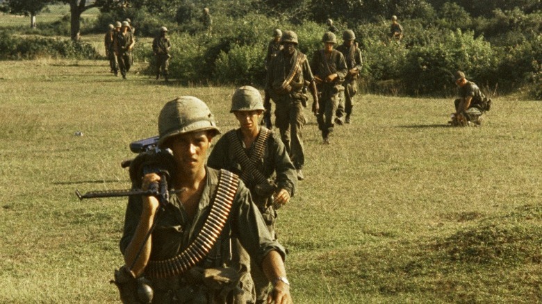 U.S. soldiers walking through field