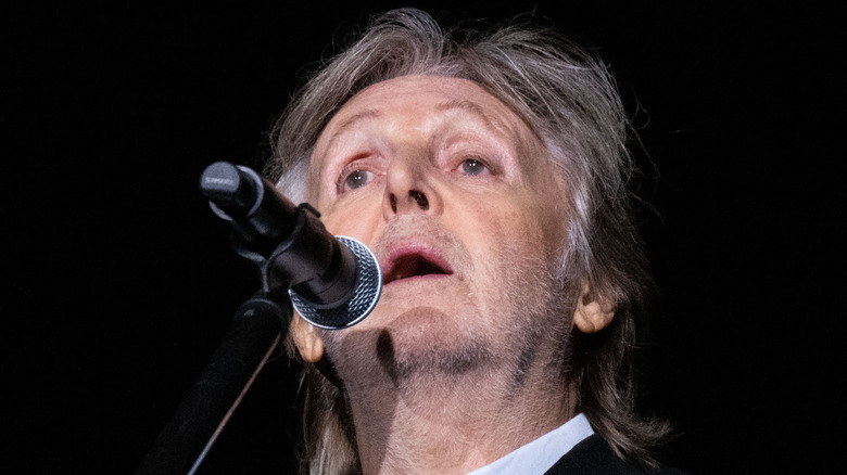 Paul McCartney singing into microphone