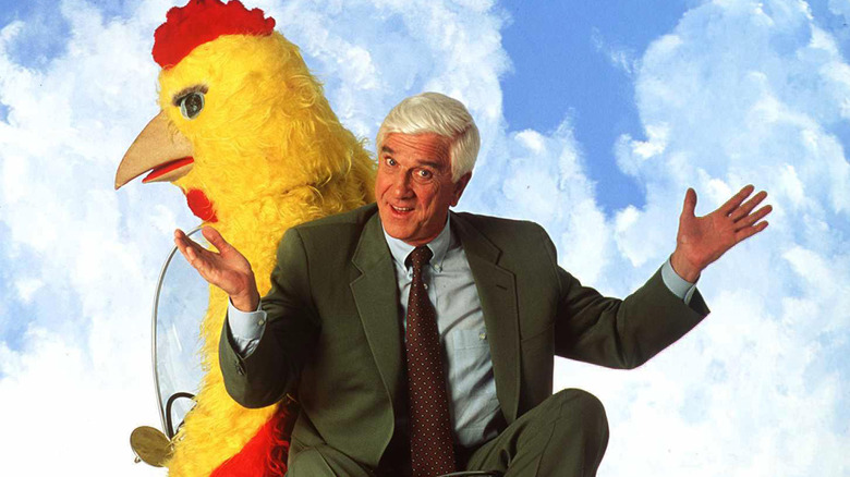 Leslie Nielsen on motorbike with person dressed as chicken