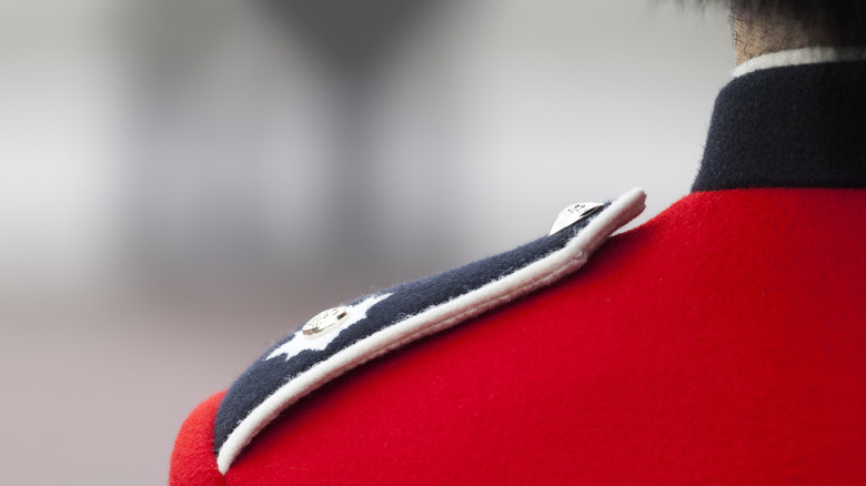 Close up of British soldier's shoulder in their red uniform