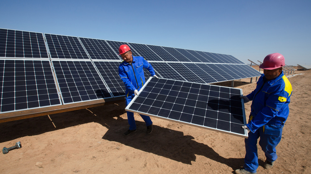 Workers removing solar panel