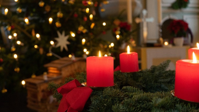 Red candles, Christmas tree background