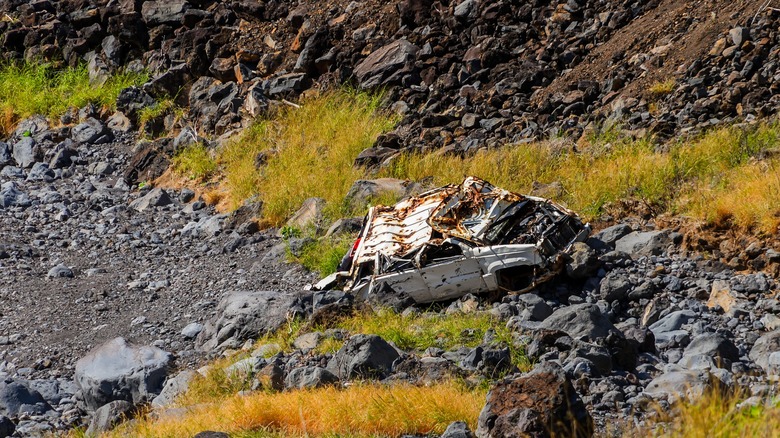 Crashed car at the bottom of a cliff