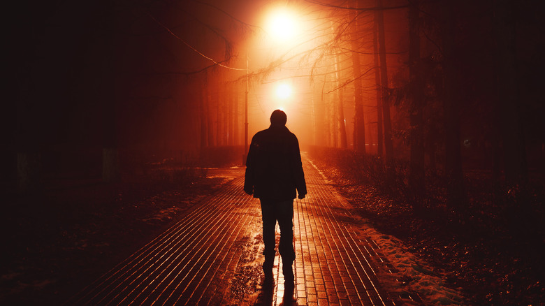 person walking alone at night