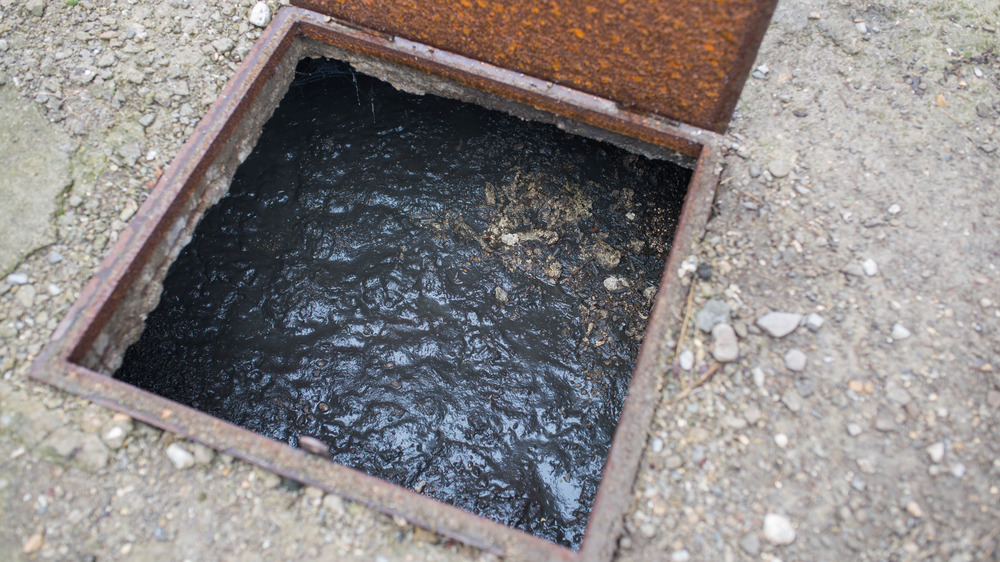 Open septic tank cover