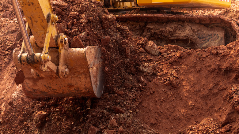 a backhoe digging a hole