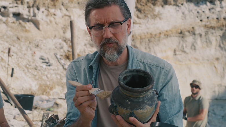 Archaeologist examining ceramic pot