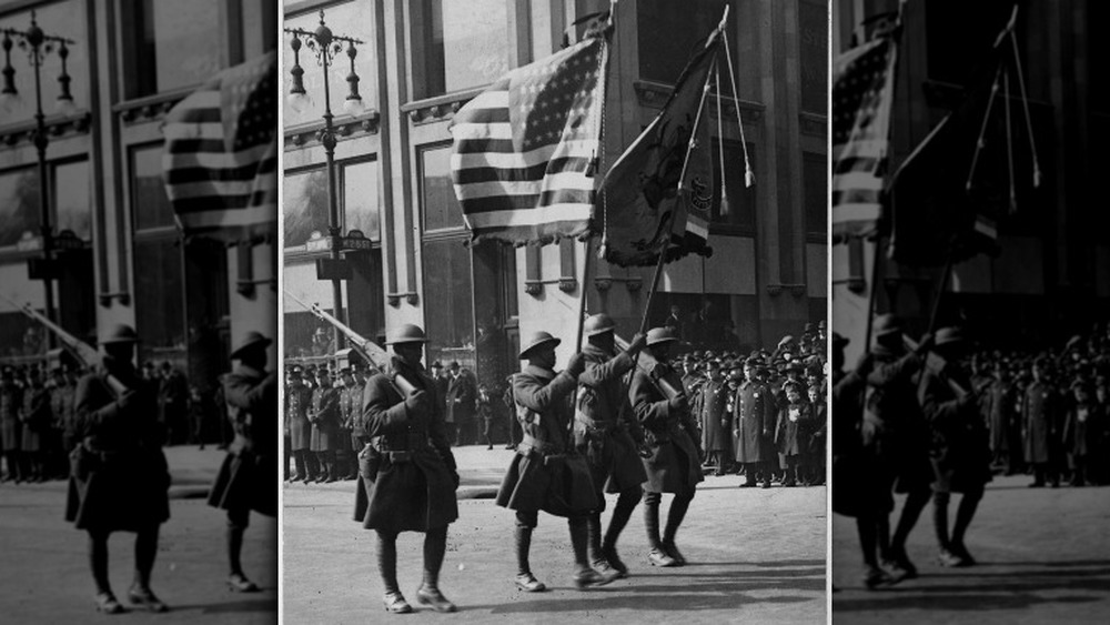 Four uniformed troops of the 369th march in the homecoming parade in NYC