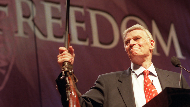 Charlton Heston hoists a musket