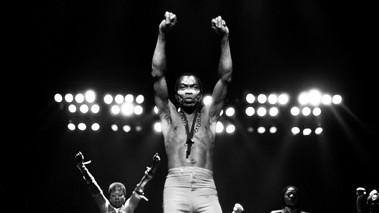 Fela Kuti on stage with arms raised