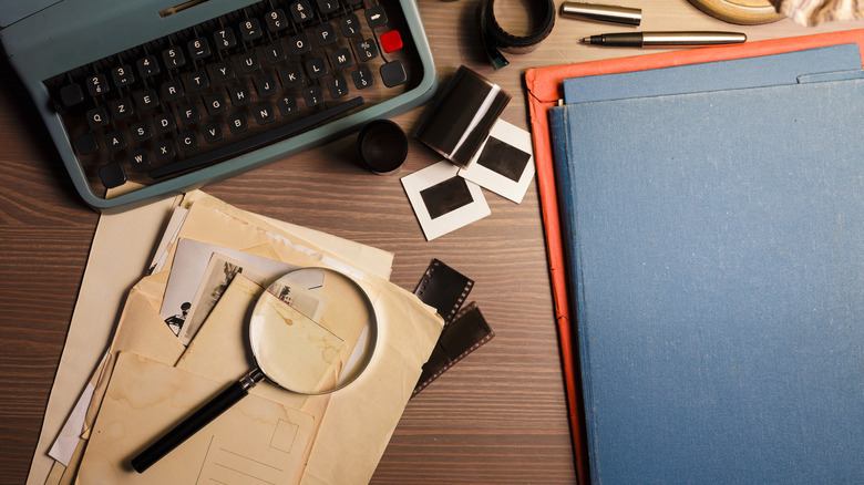 magnifying glass, typewriter, and film