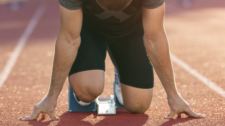 Track runner in starting position