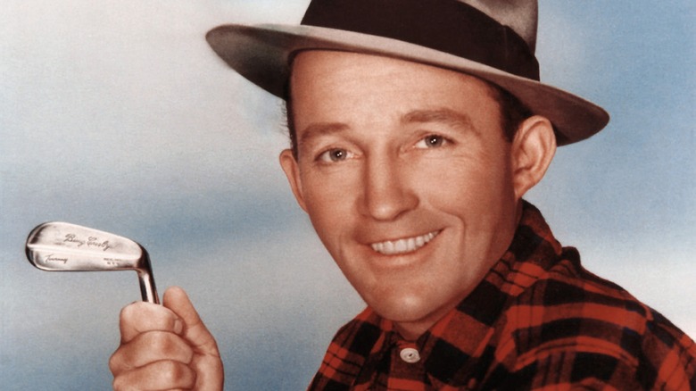 Bing Crosby smiling with a golf club