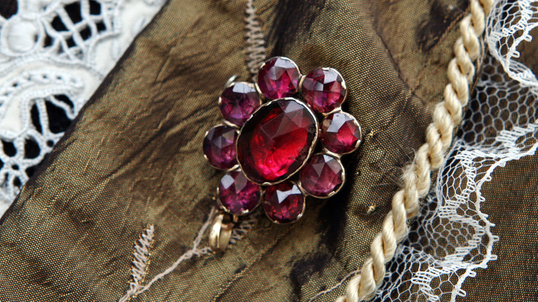 Garnet brooch on brown cloth