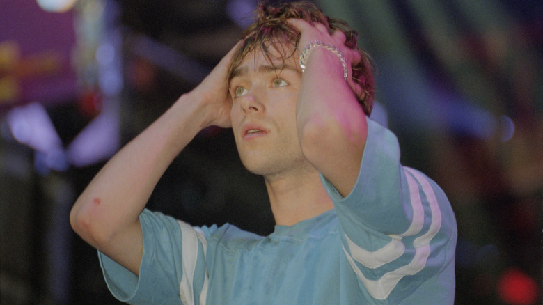 Damon Albarn holding his head