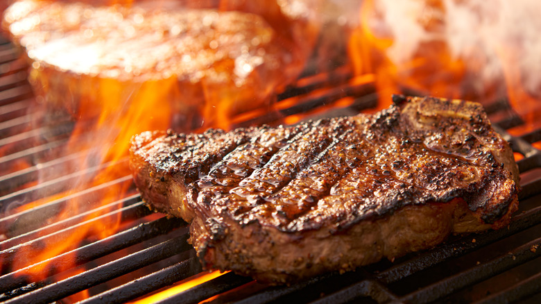 Steak grilling over a fire