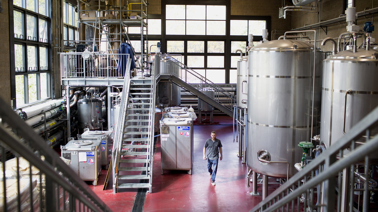 Man walking through distillery plant