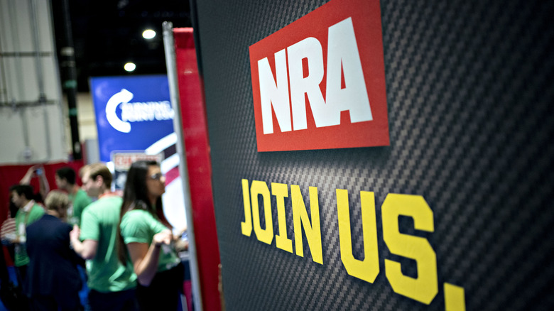 NRA sign at event crowd background