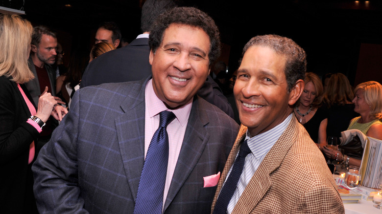 Greg and Bryant Gumbel suits smiling 