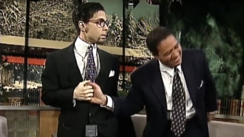 Prince and Bryant Gumbel black suits fist bumping